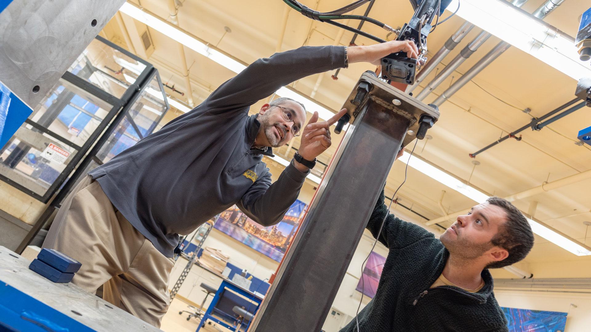 Graduate student Ben LeBlanc receives instruction from Professor Eric Hernandez in one of the Mechanical Engineering labs