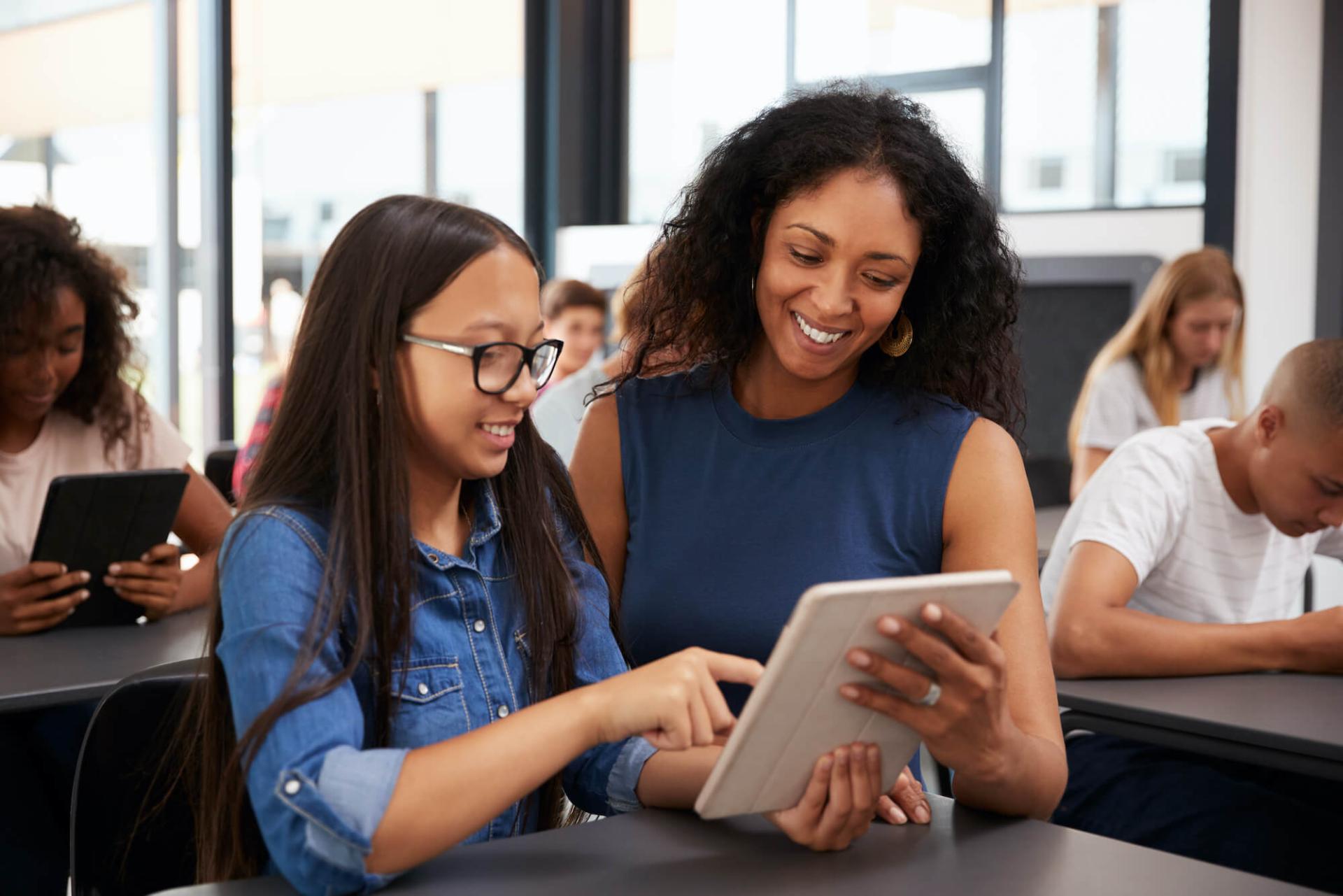 Teacher working with a student in school classroom