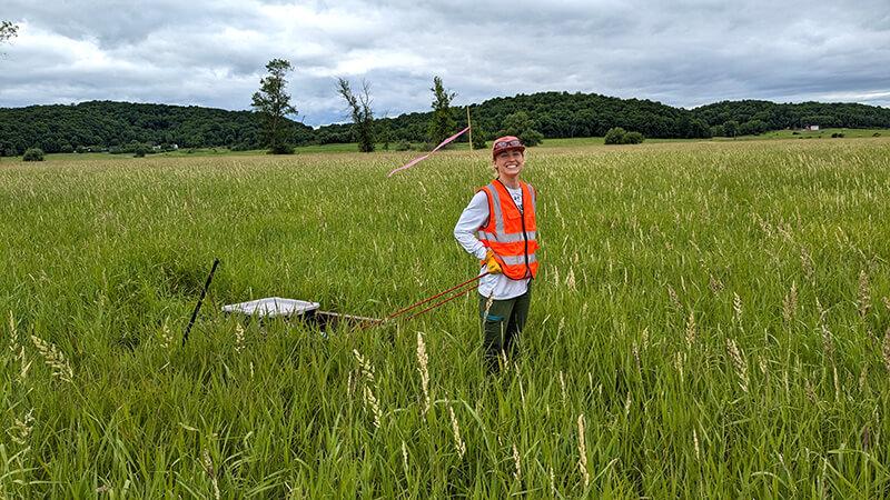 Environmental Engineering Student Victoria Horton ’25 collects vegetation samples in the Lake Champlain watershed.